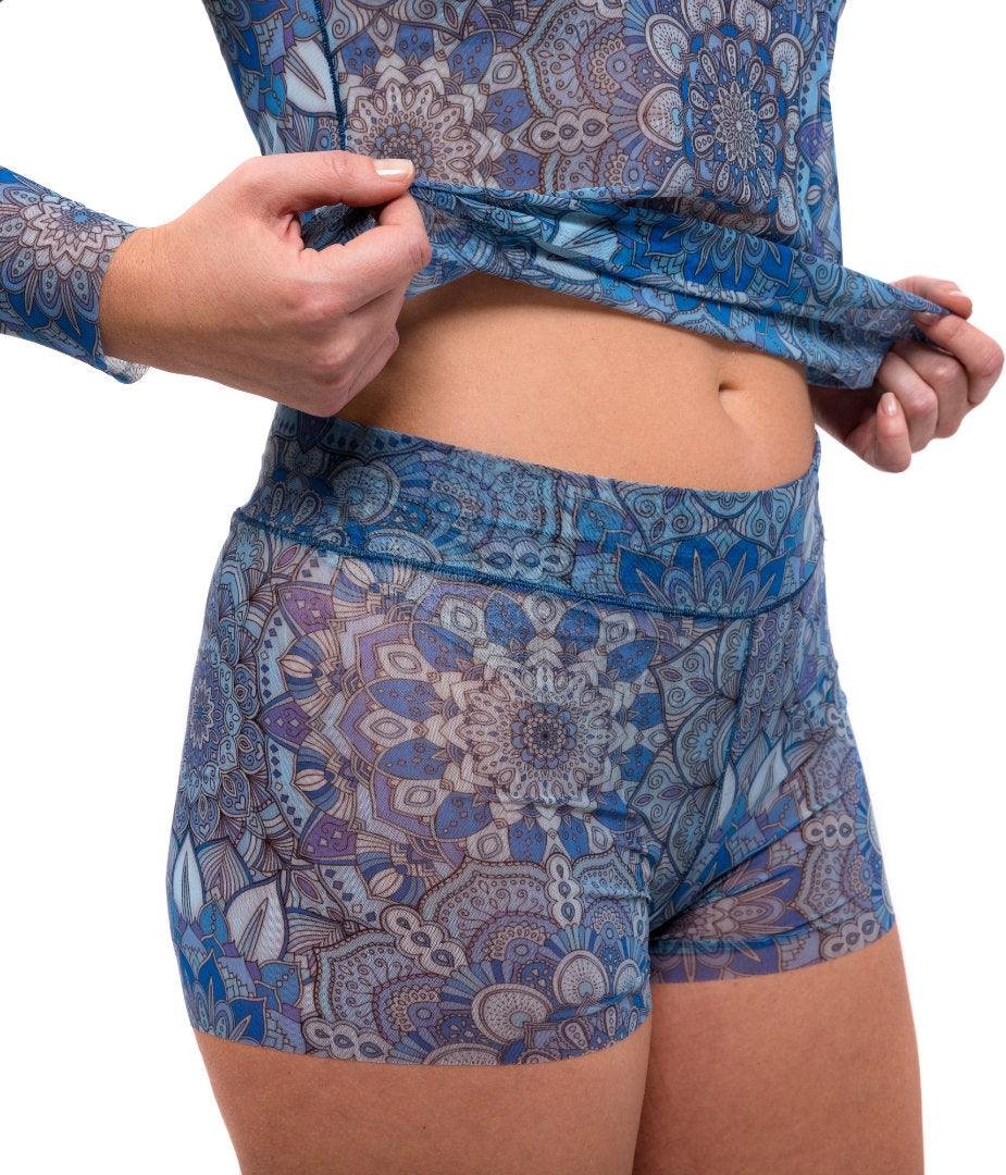 4. Woman swimming in the ocean wearing Smarttan's Tan-Through Mini Leggings in Blue Mandala, showcasing quick-drying fabric