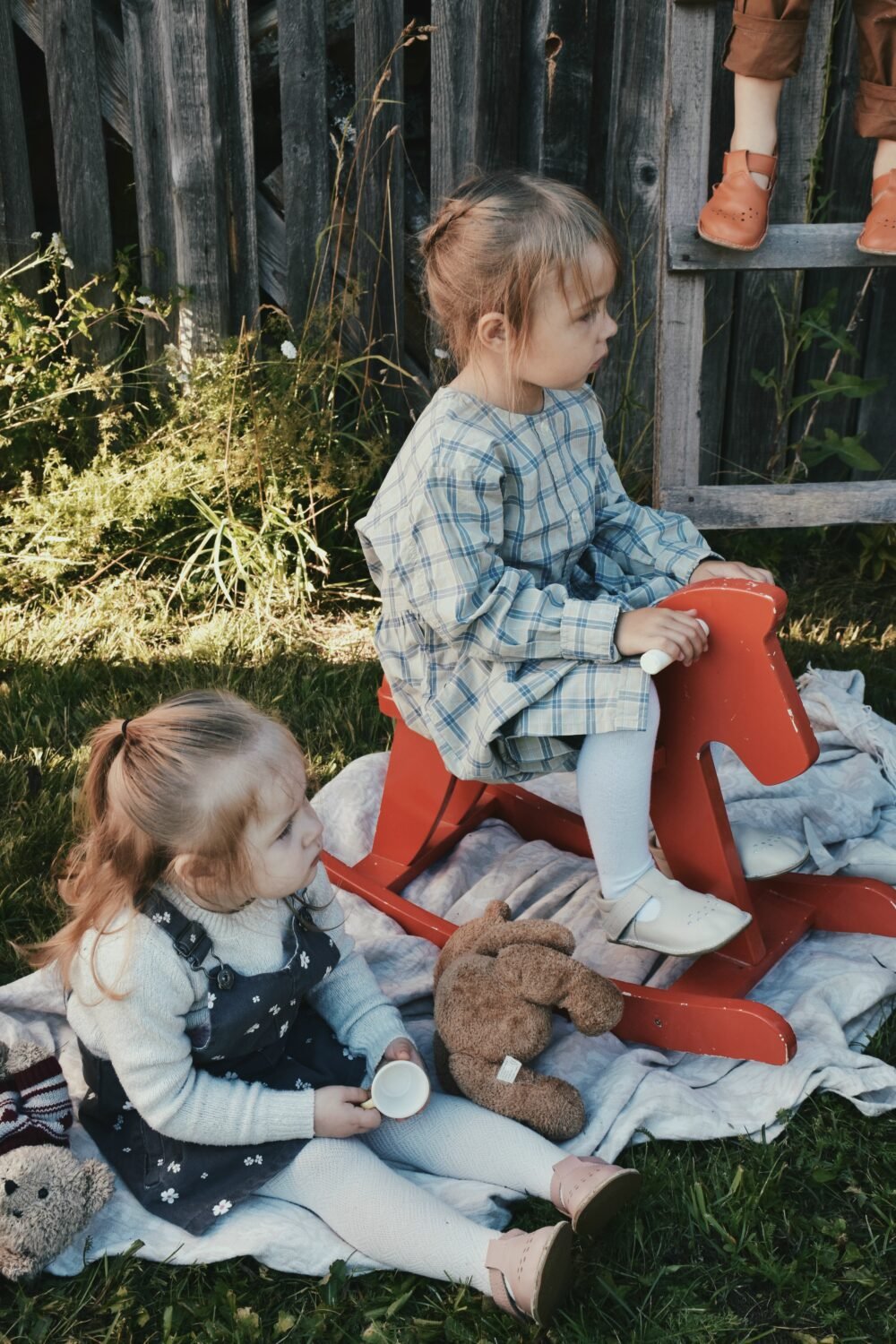 1. Lifestyle image of two girls playing outdoors, one wearing Omaking Lusti natural white leather kids' shoes