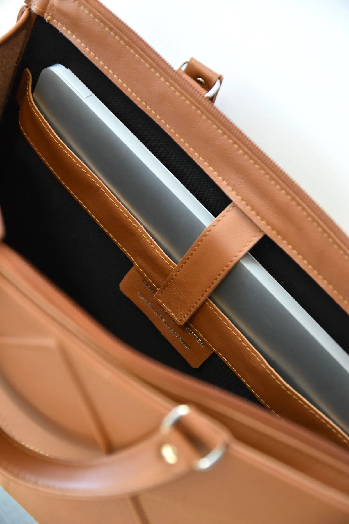 3. Close-up of Gerda Retter Design FACET handbag interior with laptop pocket, caramel brown leather