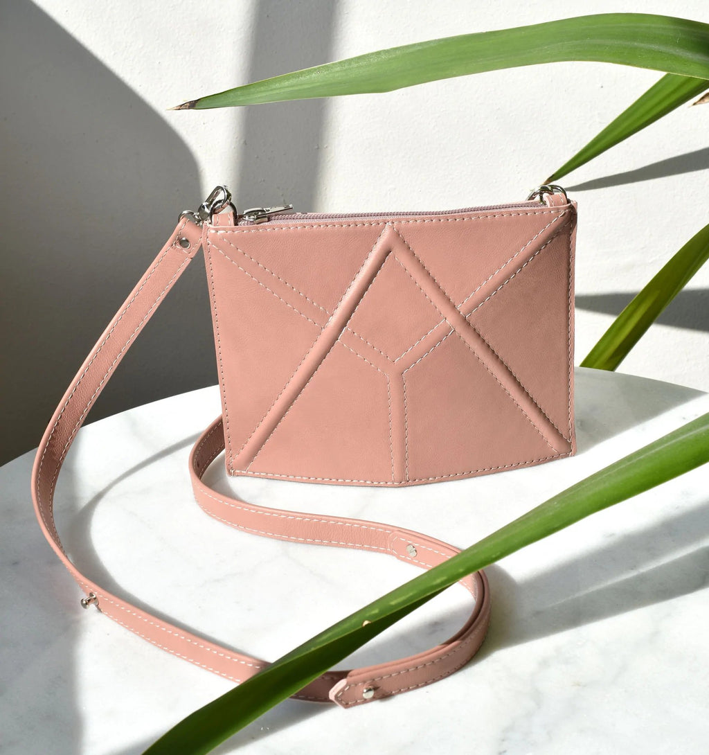 9. Studio shot of pink FACET Mini leather bag by Gerda Retter Design with adjustable strap
