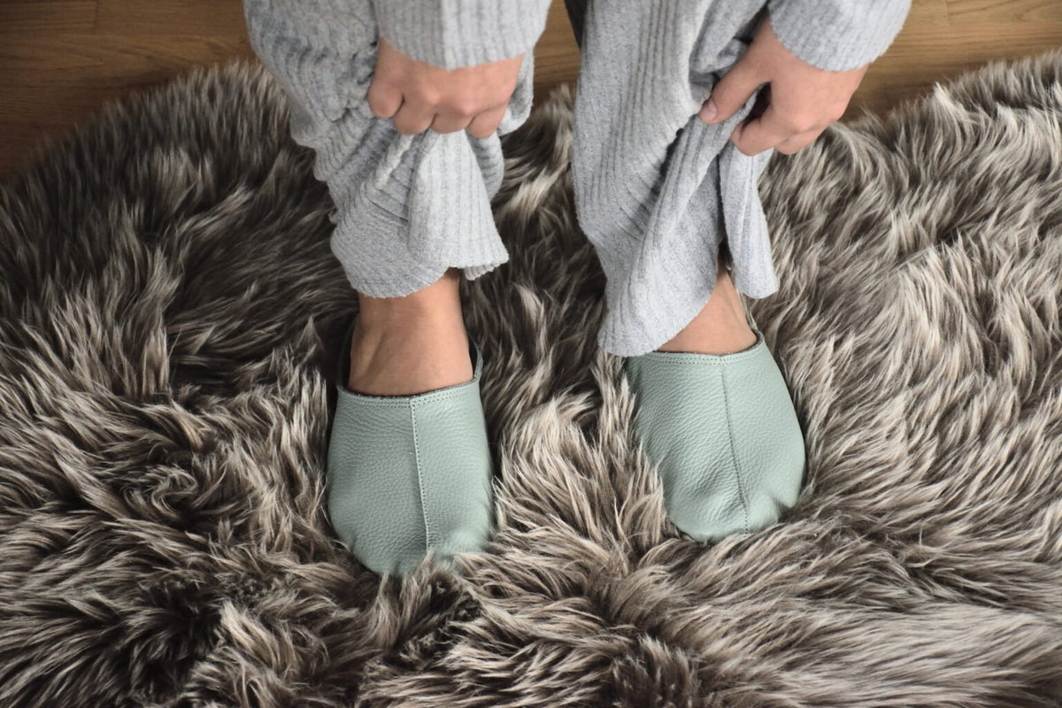 1. Women's mint Sulbi slippers by Omaking worn on a furry rug, showcasing comfort and style
