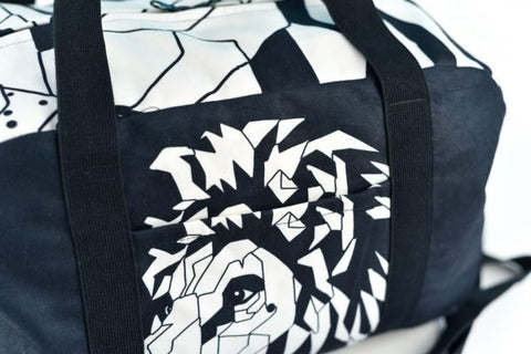 4. Close-up of Garbanota Travel Bag White Lion highlighting geometric lion design and fabric texture