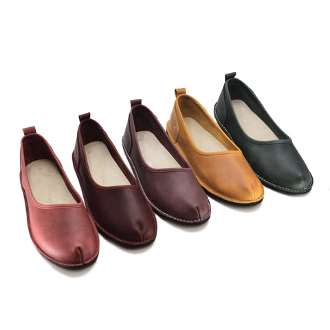 2. Collection of Kuutsid Shoes by OmaKing in multiple colors, including Bordoo, shown in studio setting