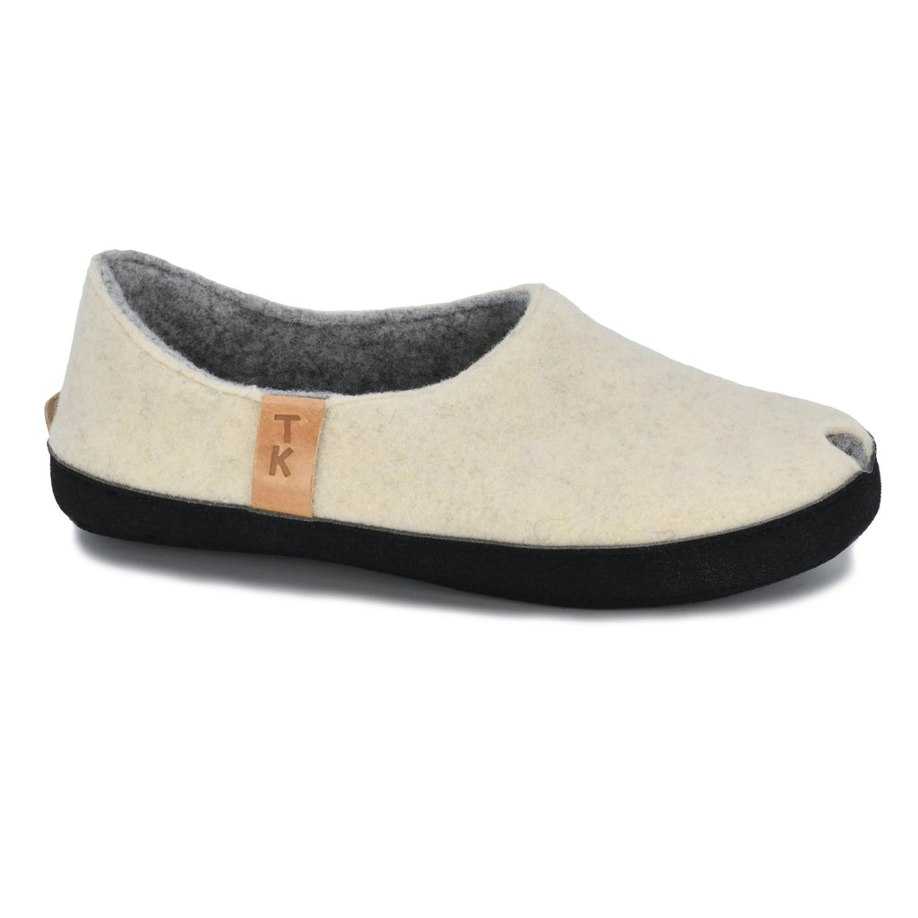 2. Side view of TOKU Budapest Slippers in natural white, featuring peek-hole design and TK branding
