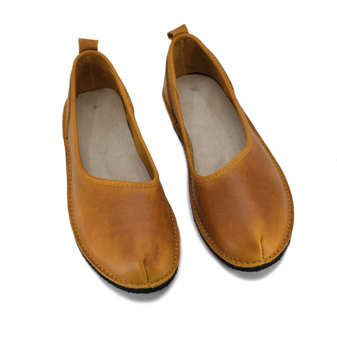 3. Studio shot of Omaking Kuutsid yellow leather shoes showing ergonomic design and EVA outsole