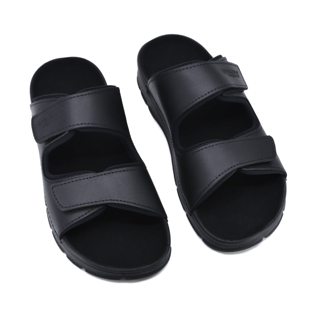 5. Studio image of Madise Sandals in black, featuring two adjustable velcro straps and PU outsole