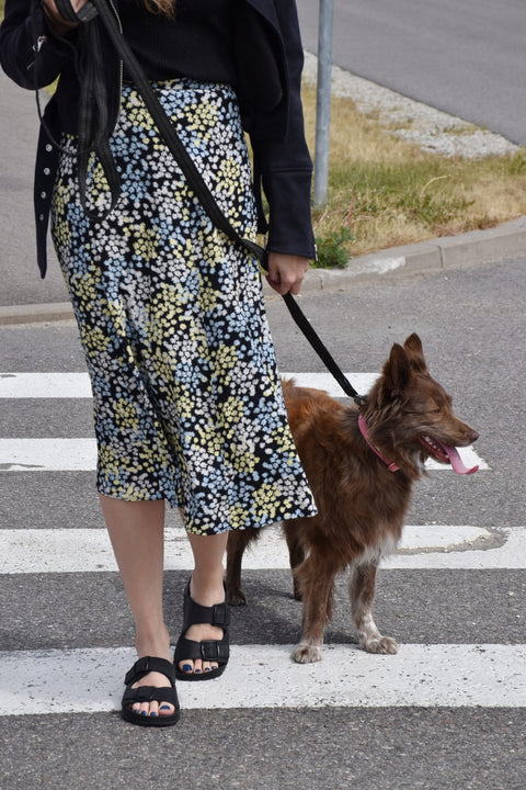 1. Women's Meeliku black sandals by Omaking worn while walking a dog, showcasing versatile style