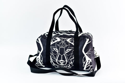 1. Garbanota Travel Bag White Wolf in black with geometric wolf design, featuring long strap and handles, studio setting
