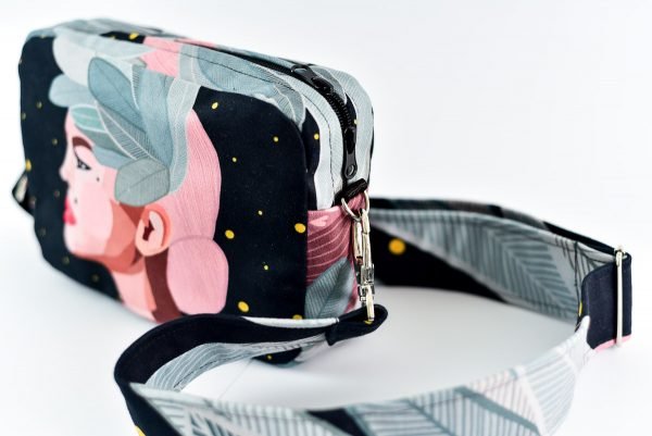 3. Garbanota Valerie shoulder bag with wide strap, featuring exclusive illustration, shown from side in studio