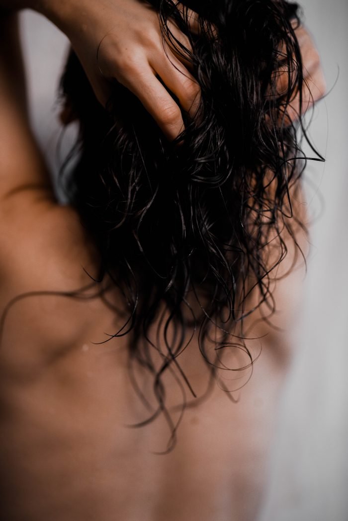 14. Person applying V.O.H solid shampoo to wet hair, highlighting eco-friendly hair care routine