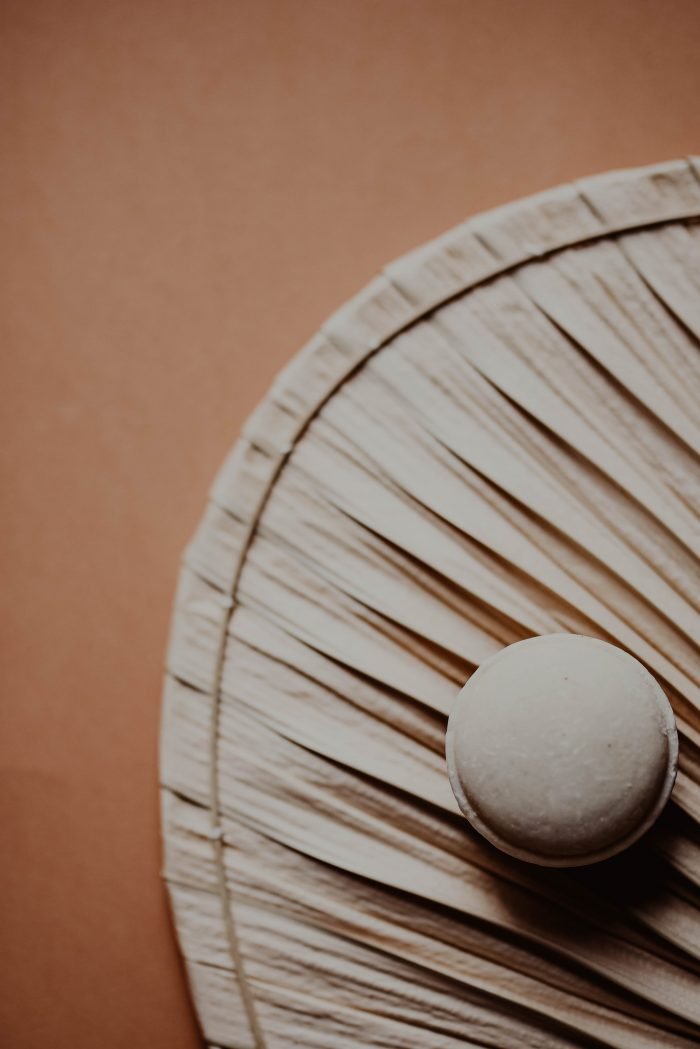 5. Close-up of V.O.H solid shampoo on a textured surface, highlighting eco-friendly design