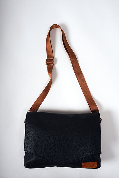 6. Studio image of Ally Scandic Black Coffee handbag with flap closed, showcasing sleek design and brown strap