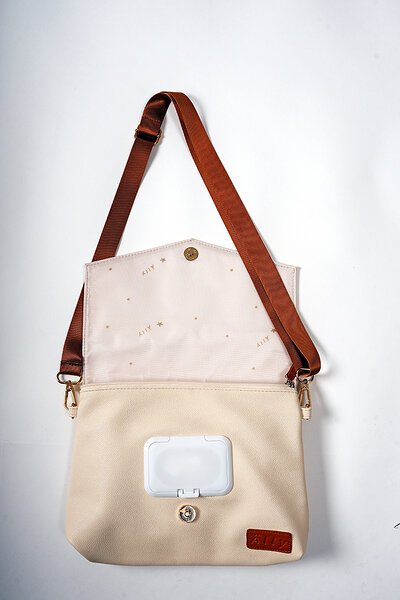 7. Studio shot of Ally Scandic Älly Handbag in Cappuccino, highlighting interior and wet wipes pocket