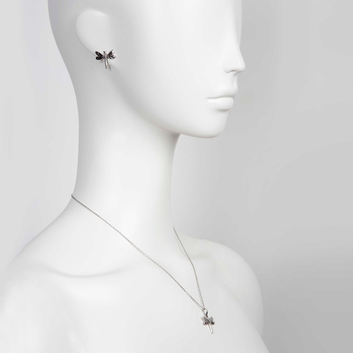 1. Woman wearing Tanel Veenre Dark Dragonfly earrings and matching pendant necklace in rhodium-plated silver