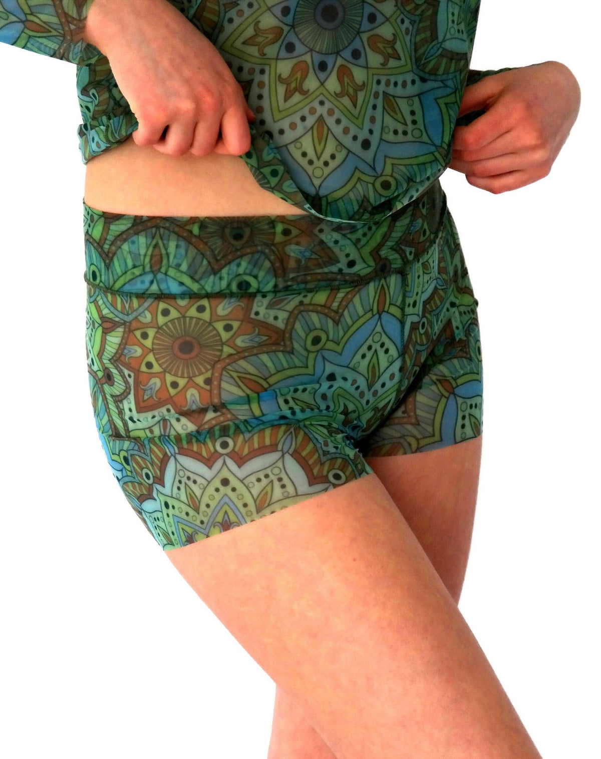 2. Women's green mandala tan-through mini leggings, side view with matching top, highlighting stretchy fit