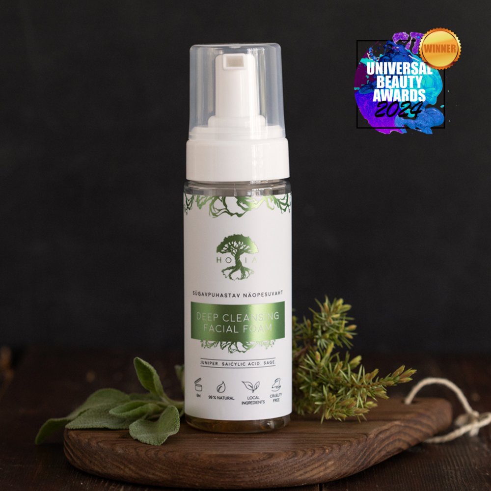 2. HOIA homespa Deep Cleansing Facial Foam with award badge, displayed with juniper and sage on wooden surface