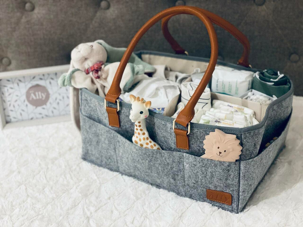 2. Close-up of Ally Scandic diaper caddy organizer filled with baby essentials, featuring felt and vegan leather