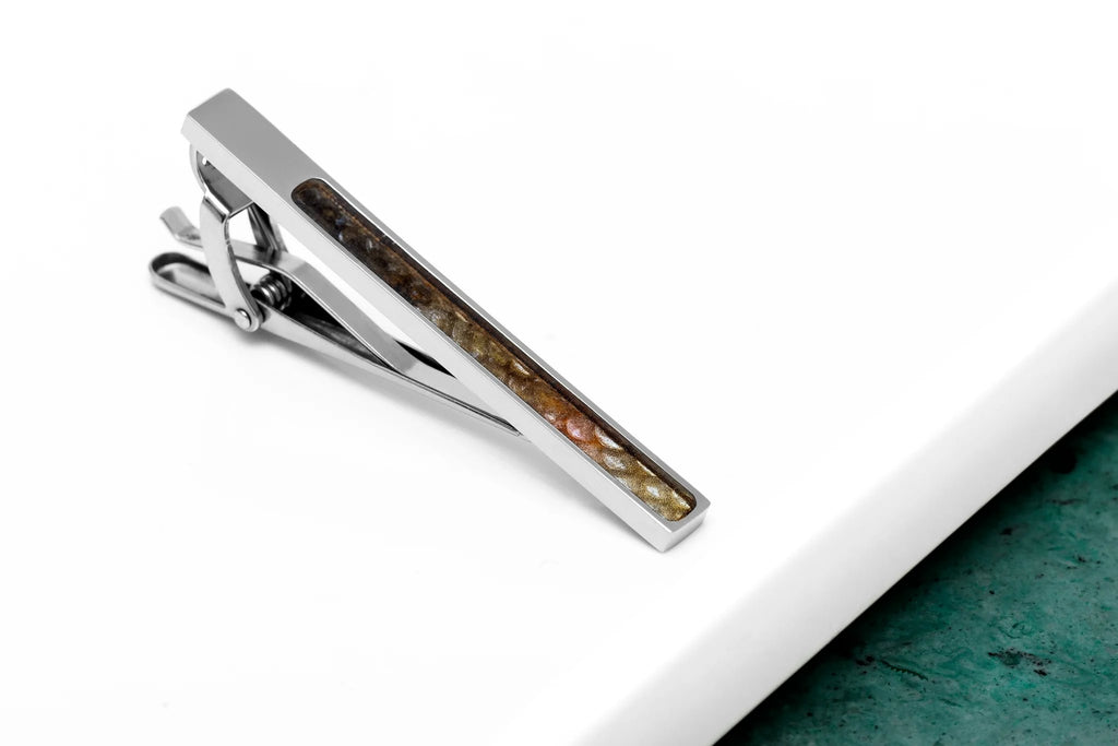 1. Stainless steel tie clip with red-spotted fish leather inlay on white and green background