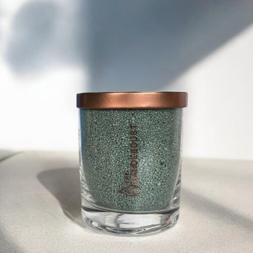 2. Candledust emerald powder candle in glass with copper lid, shown in natural light