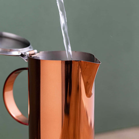 3. Water being poured into La Cafetière copper and silver stovetop coffee maker with open lid
