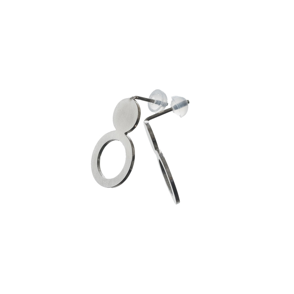 4. Studio shot of Lentsius Arc silver earrings with silicone stoppers, showing innovative design and craftsmanship