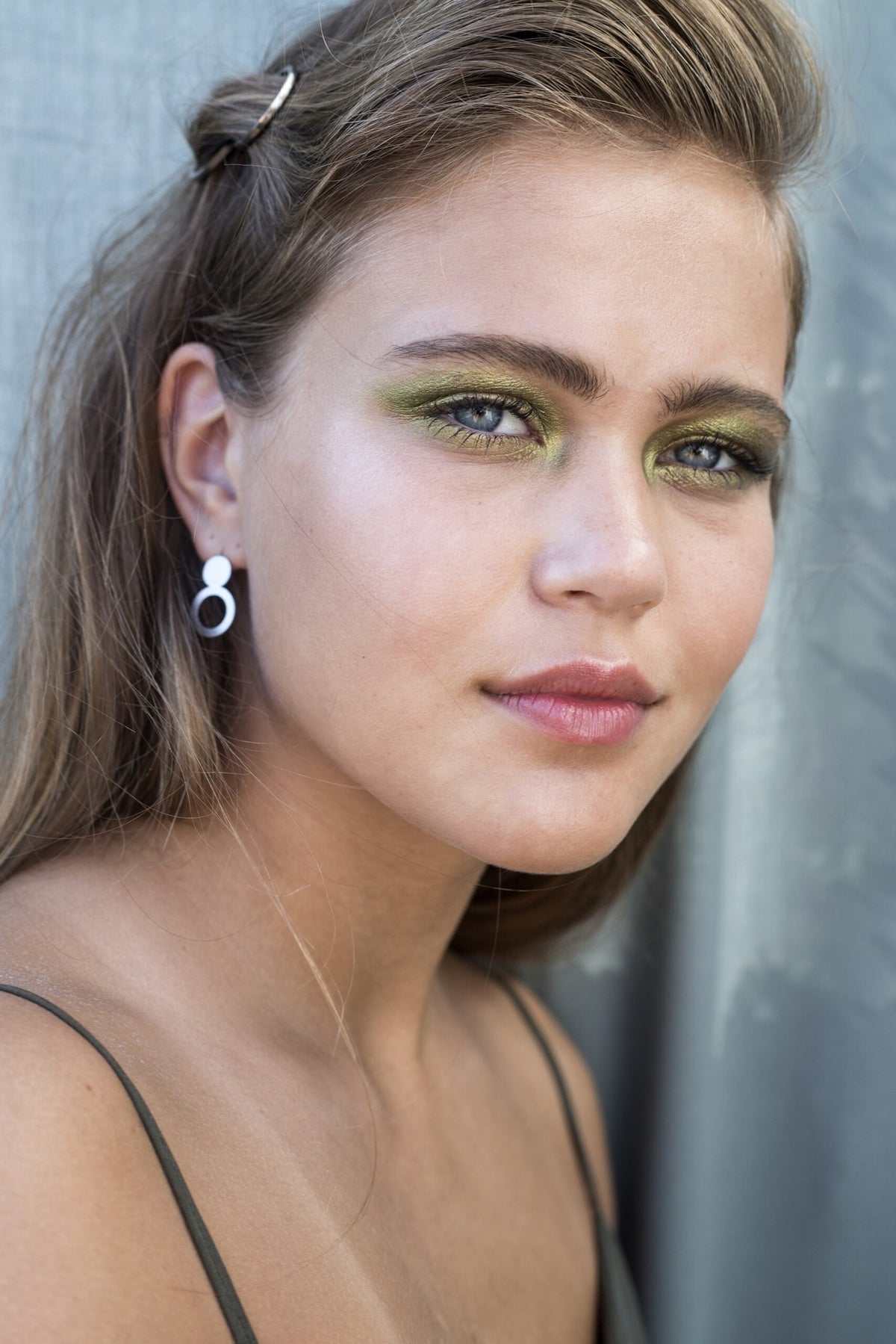 3. Woman with Lentsius Arc silver earrings, emphasizing eco-conscious style and hypoallergenic material
