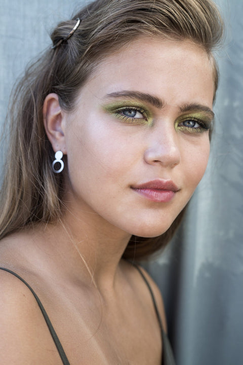 3. Woman with Lentsius Arc silver earrings, emphasizing eco-conscious style and hypoallergenic material
