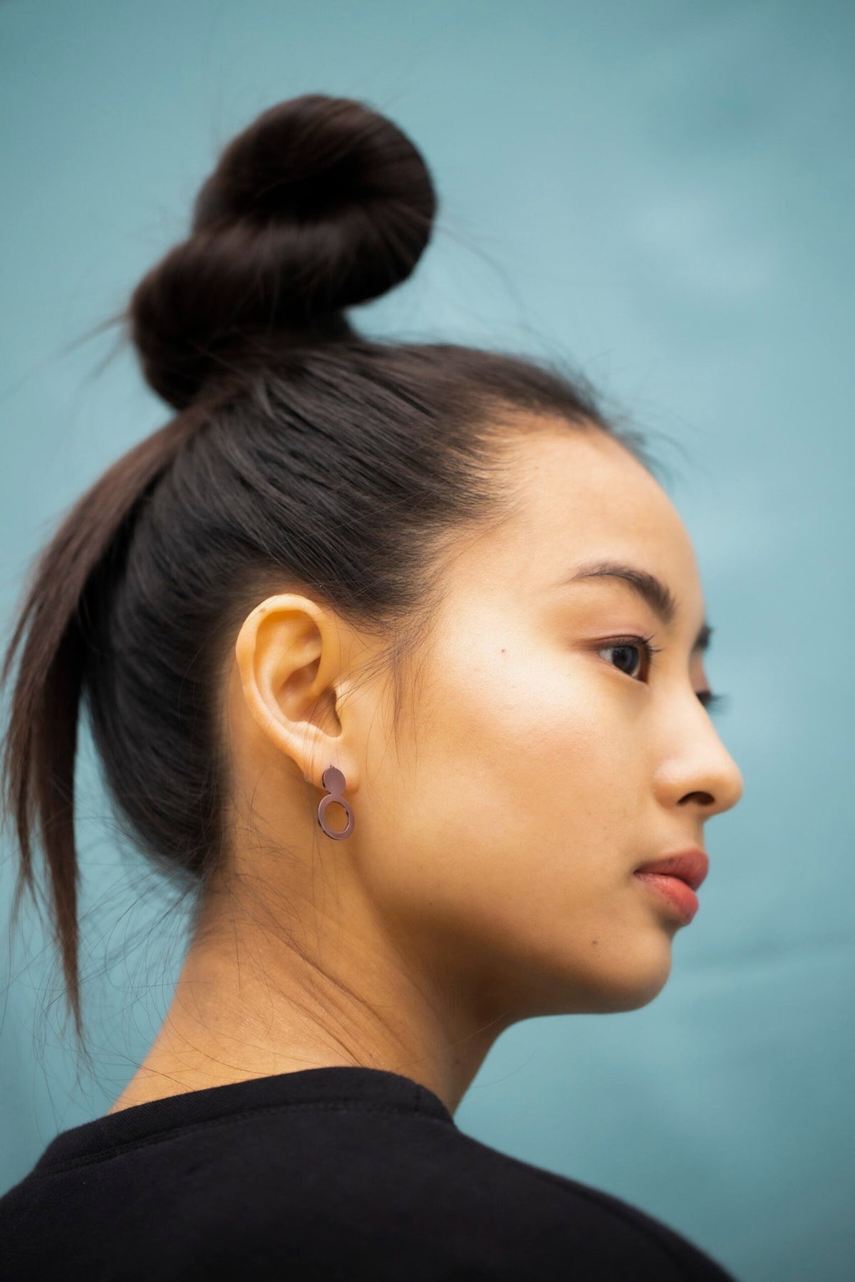 2. Side profile of woman with Lentsius Arc Purple earrings, highlighting eco-conscious style