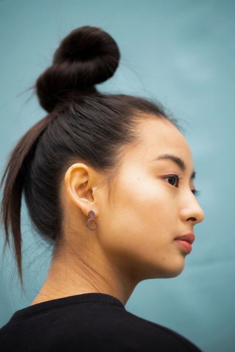 2. Side profile of woman with Lentsius Arc Purple earrings, highlighting eco-conscious style