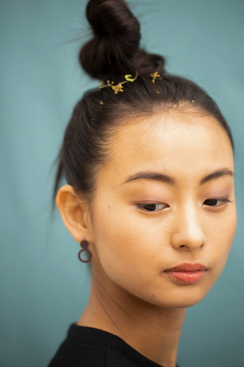 5. Close-up of woman wearing Lentsius Arc Purple earrings, showcasing hypoallergenic stainless steel