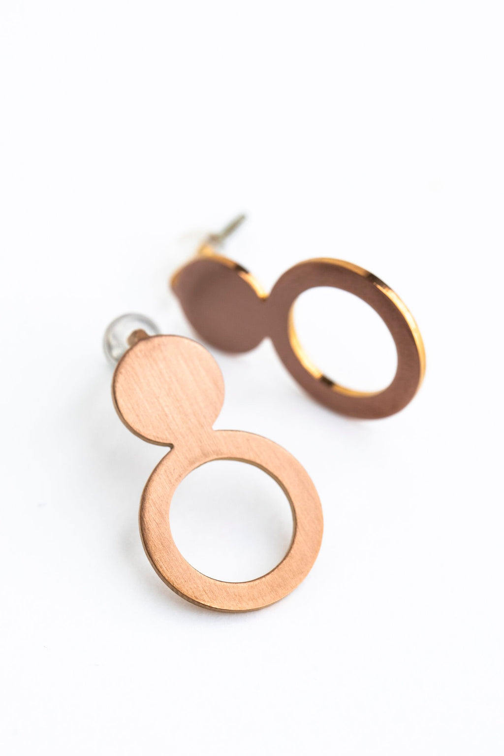 7. Studio shot of Lentsius Arc rose gold earrings, displaying unique shape and PVD coating