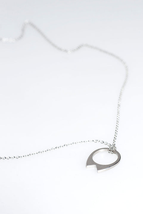 2. Close-up of Lentsius stainless steel necklace with circular pendant on white background
