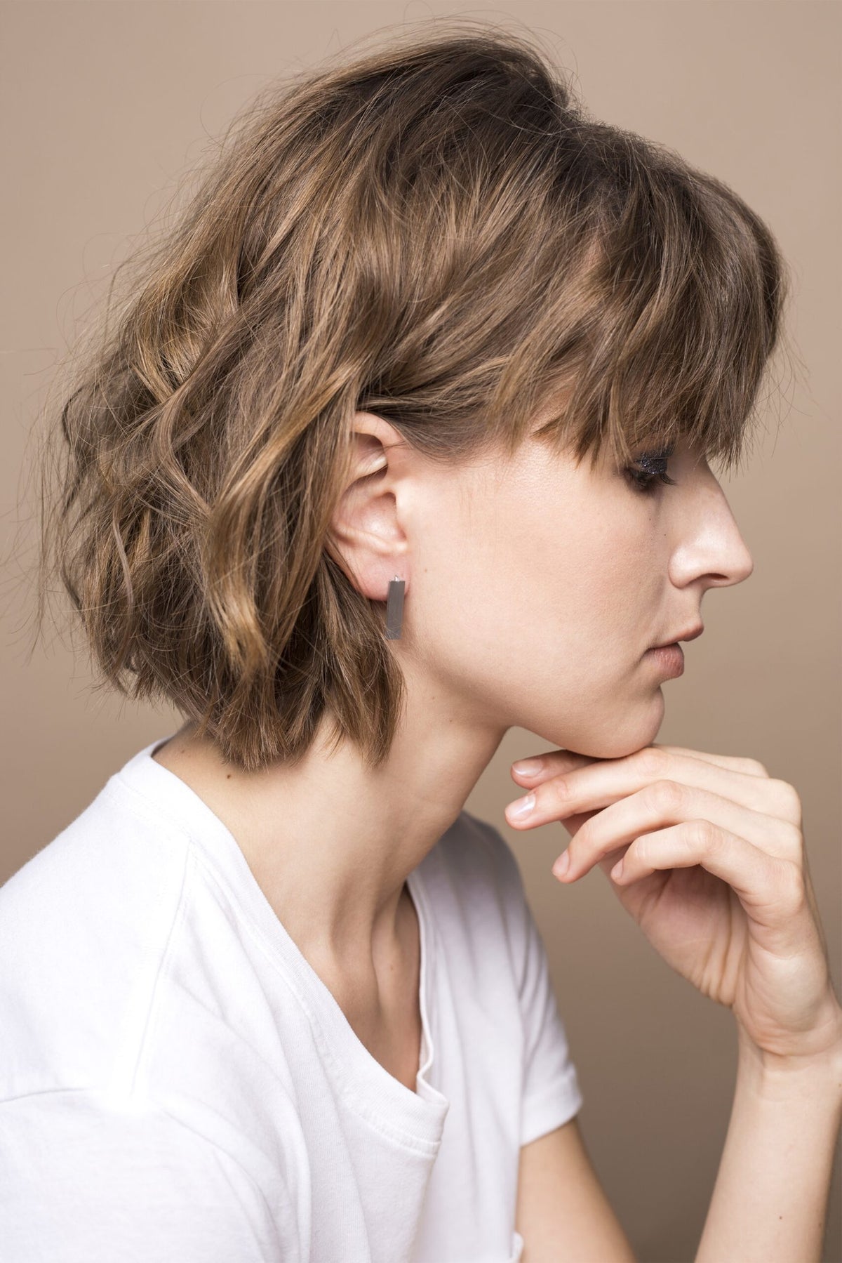 2. Women's Lentsius Corner silver earrings in studio setting, highlighting elegant brushed stainless steel design