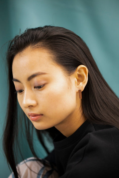 5. Woman wearing Lentsius Corner rose gold earrings, highlighting sustainable craftsmanship