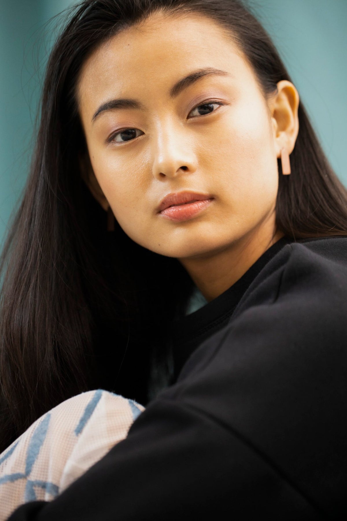 2. Close-up of woman wearing Lentsius Corner rose gold earrings, highlighting brushed finish