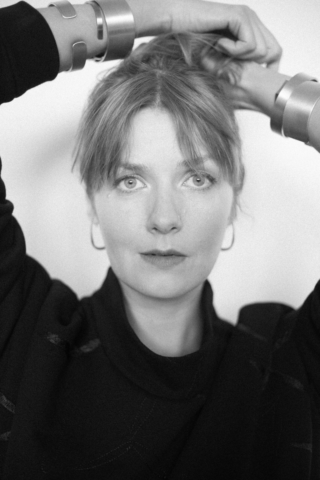 5. Black and white portrait of woman wearing Lentsius Curvi earrings, highlighting minimalist design