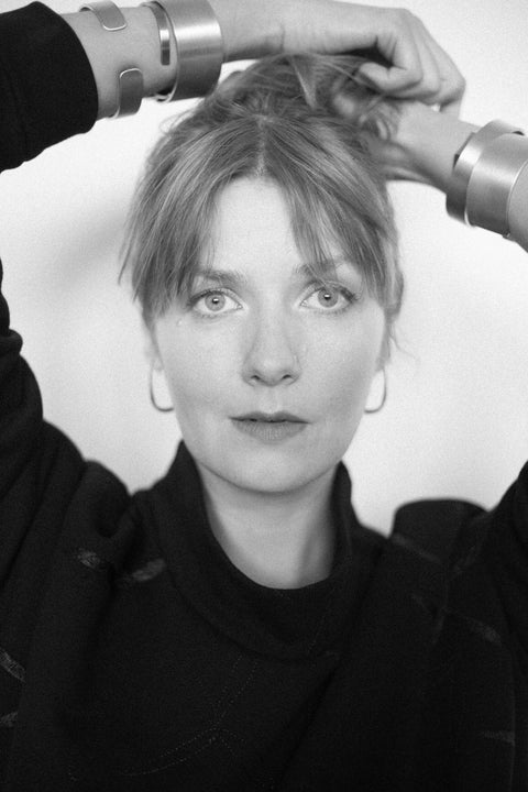 5. Black and white portrait of woman wearing Lentsius Curvi earrings, highlighting minimalist design