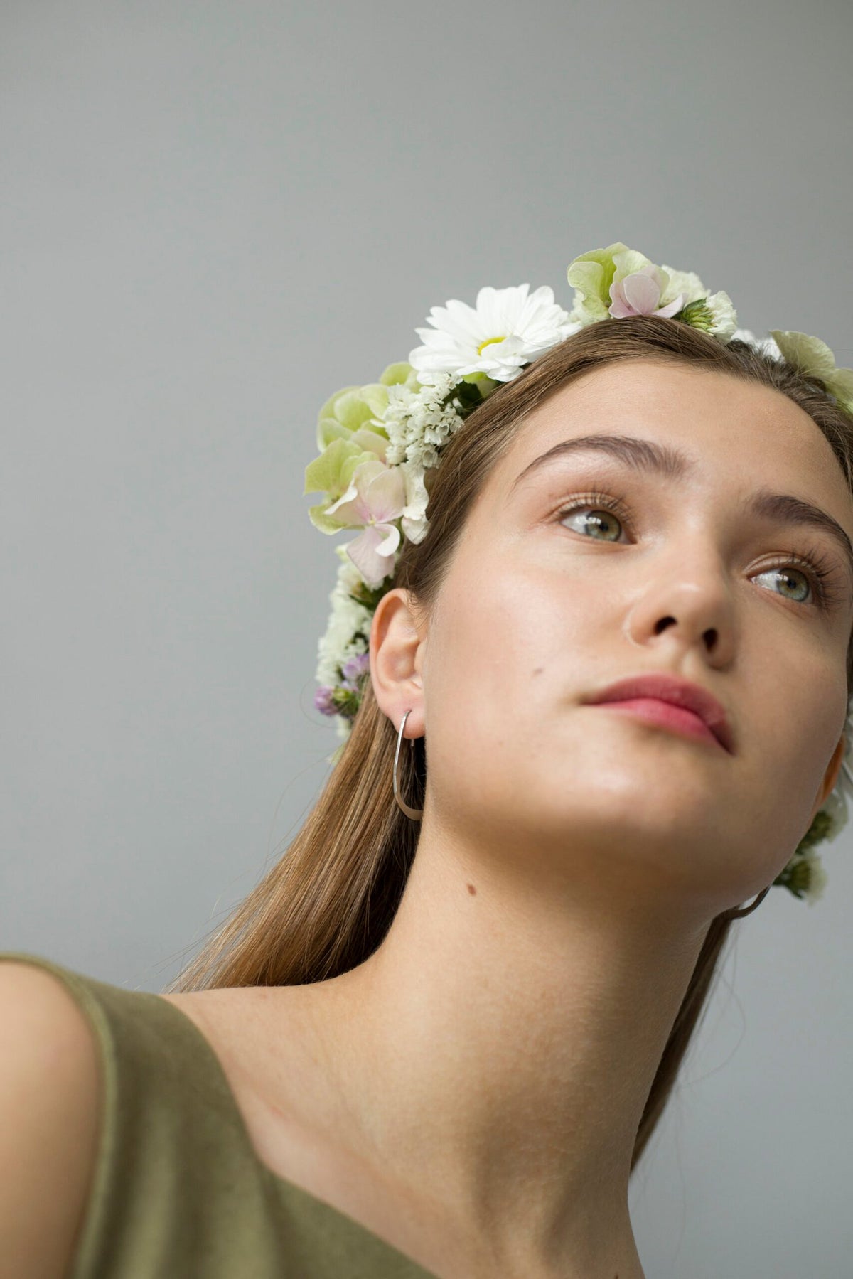 2. Close-up of woman wearing Lentsius Curvi earrings with flower crown, highlighting eco-conscious style
