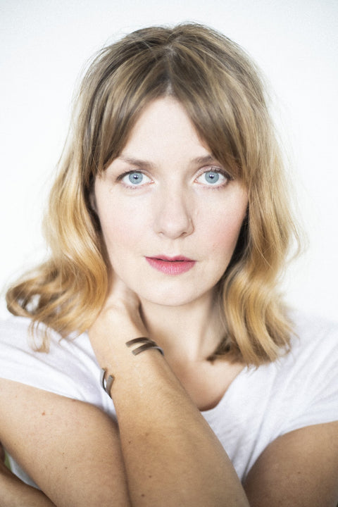 2. Close-up of woman wearing Lentsius Exo bracelet, highlighting sleek stainless steel finish