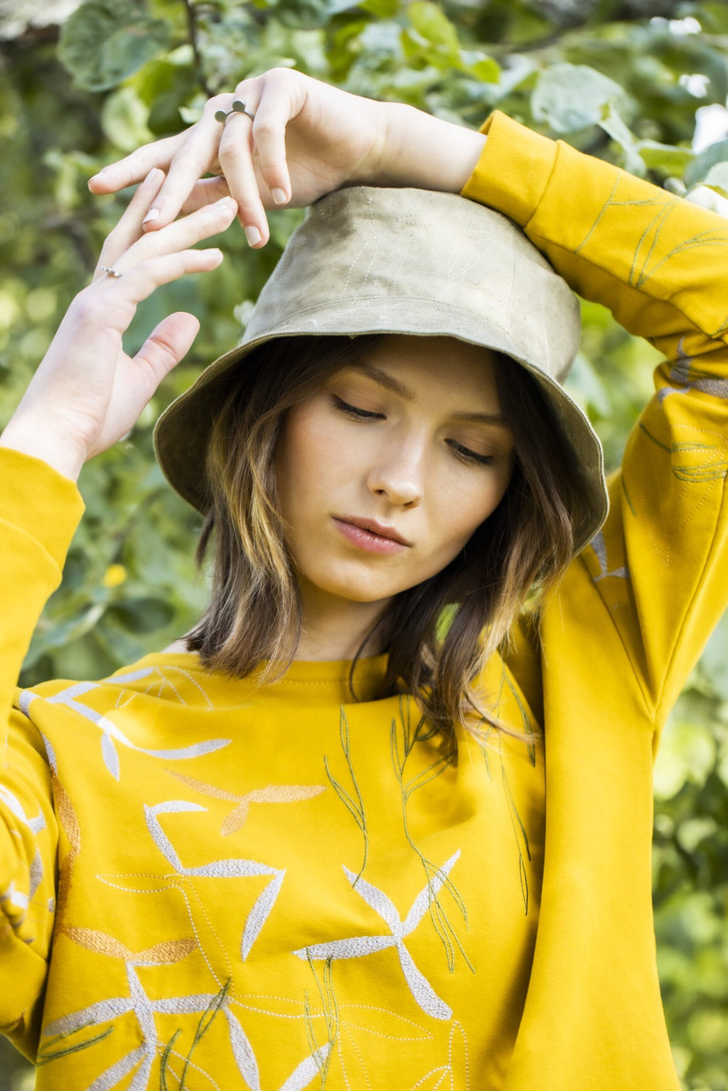 1. Woman wearing Lentsius Auris ring in outdoor setting, showcasing sustainable fashion