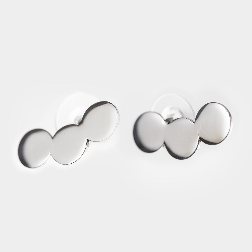 3. Studio shot of Lentsius Baca earrings, featuring upcycled stainless steel with a sleek polished finish