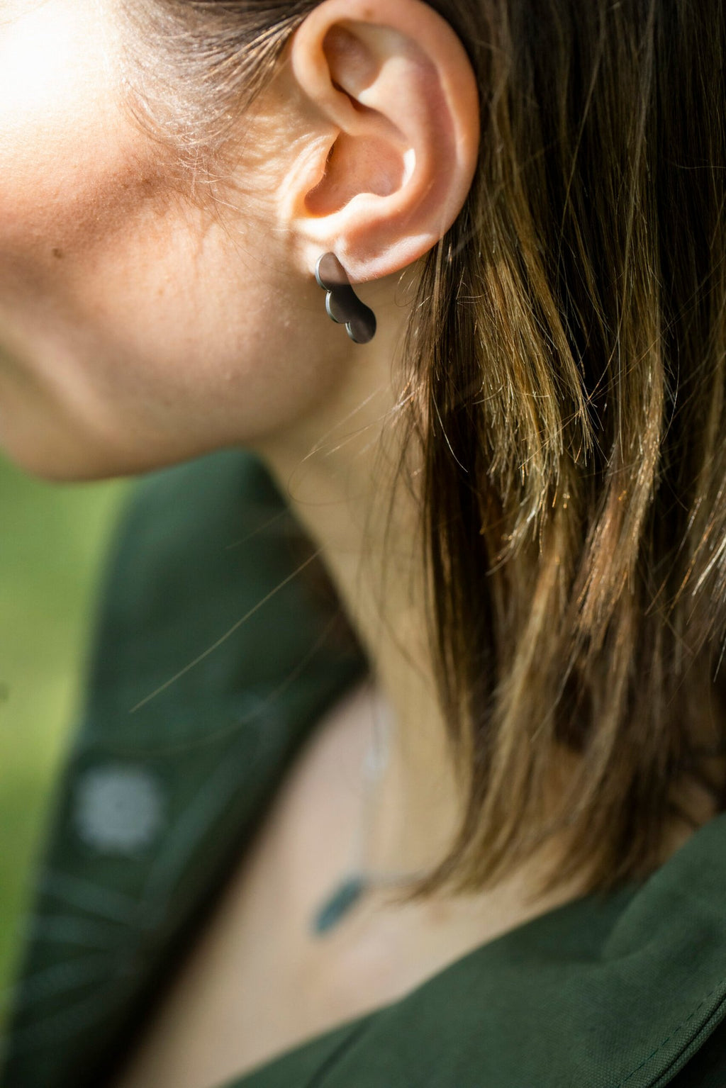5. Close-up of Lentsius Rubus earrings on woman's ear, showing hypoallergenic stainless steel