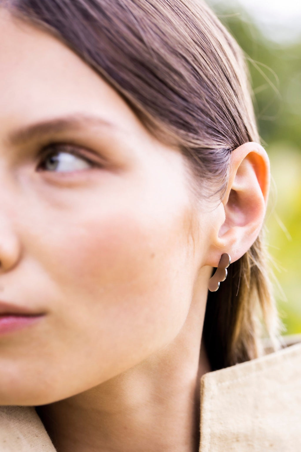 3. Side view of woman wearing Lentsius Rubus earrings, highlighting eco-conscious design