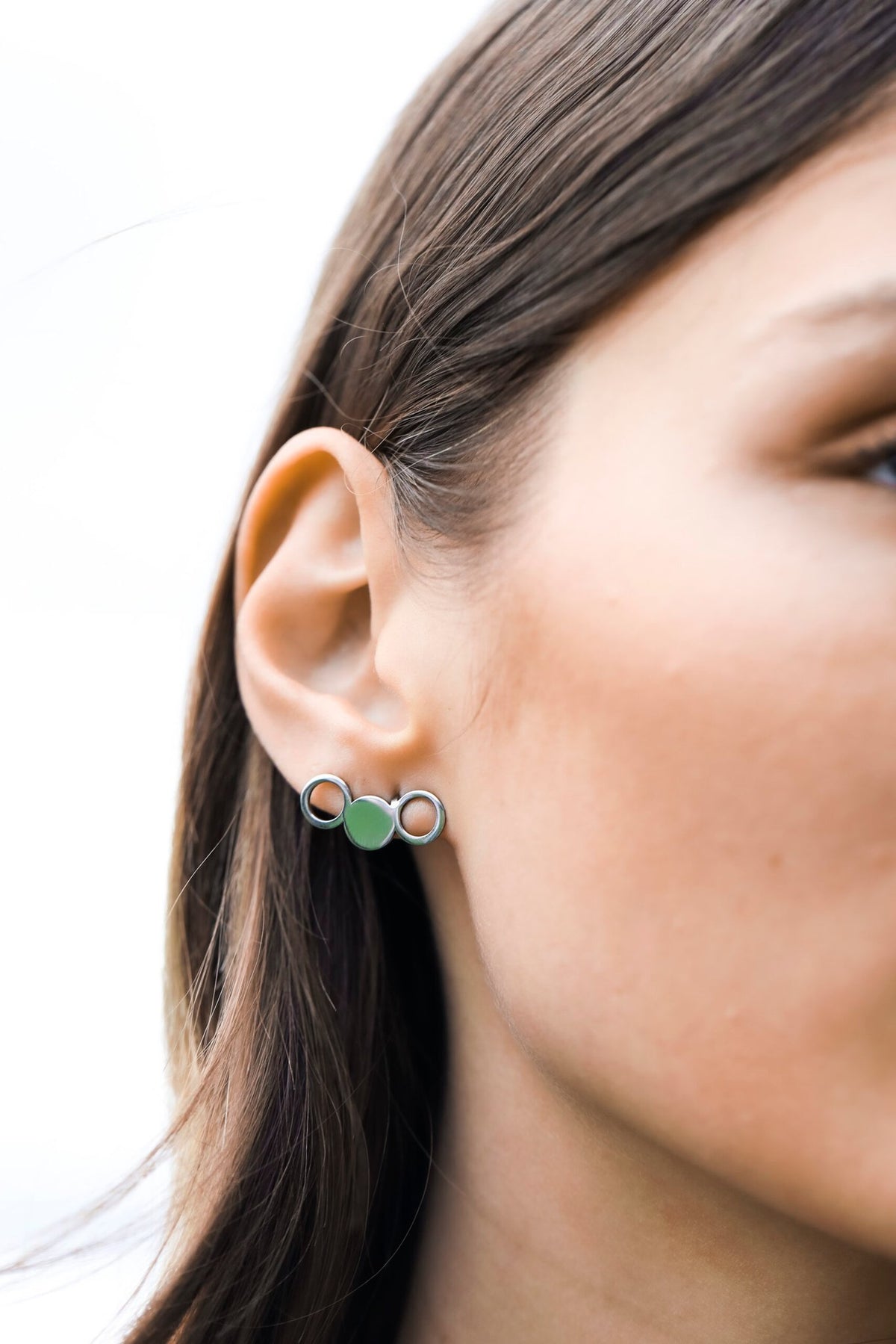 2. Close-up of woman wearing Lentsius Silva earrings with polished finish