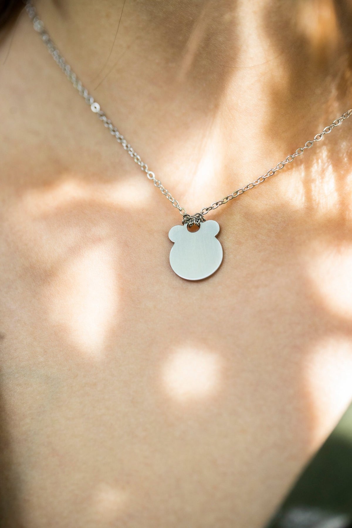 1. Women's Ursa necklace by Lentsius in stainless steel, worn outdoors