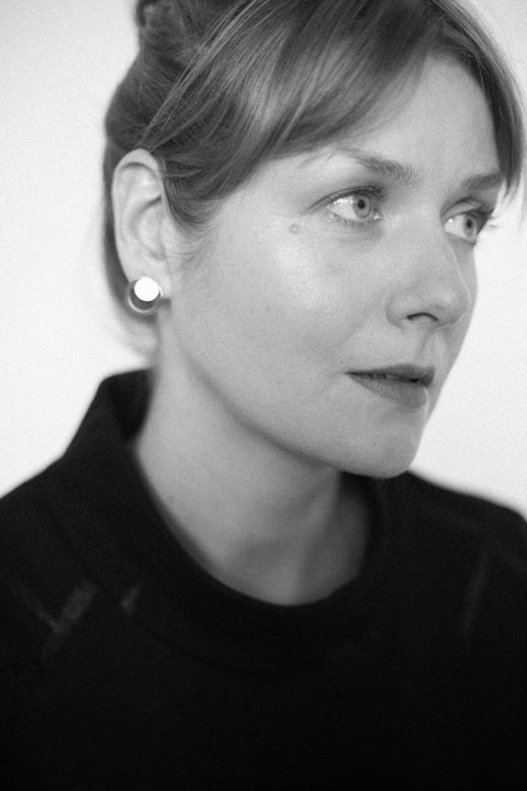 2. Close-up of woman wearing Lentsius Luna earrings, highlighting eco-conscious design