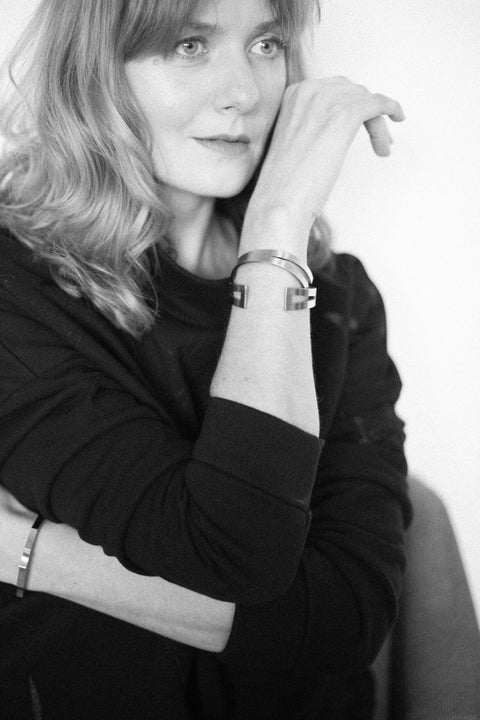 1. Woman wearing Lentsius Octo bracelet in lifestyle setting, showcasing modern Scandinavian style