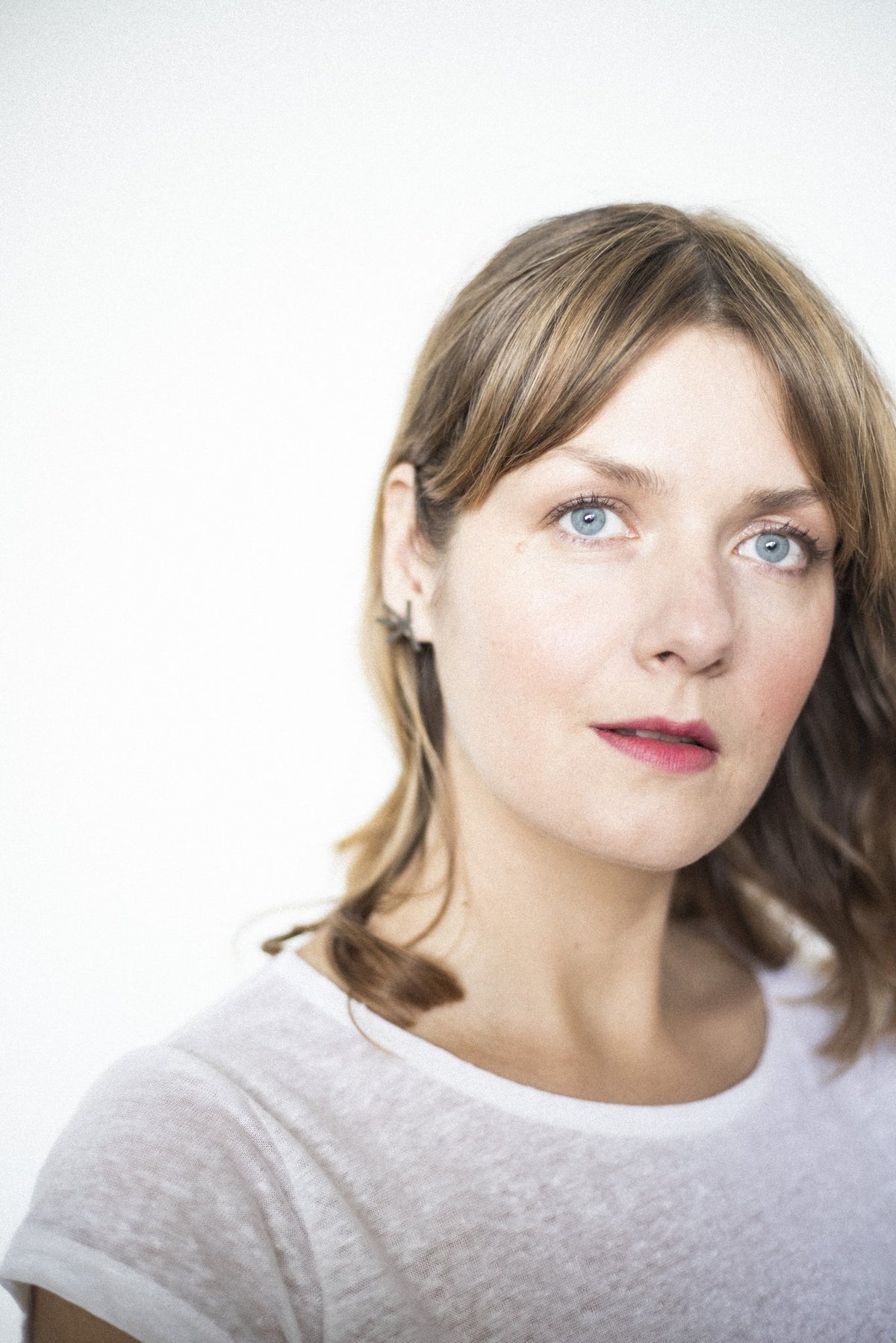 2. Close-up of woman wearing Lentsius Stella earrings, highlighting sustainable design