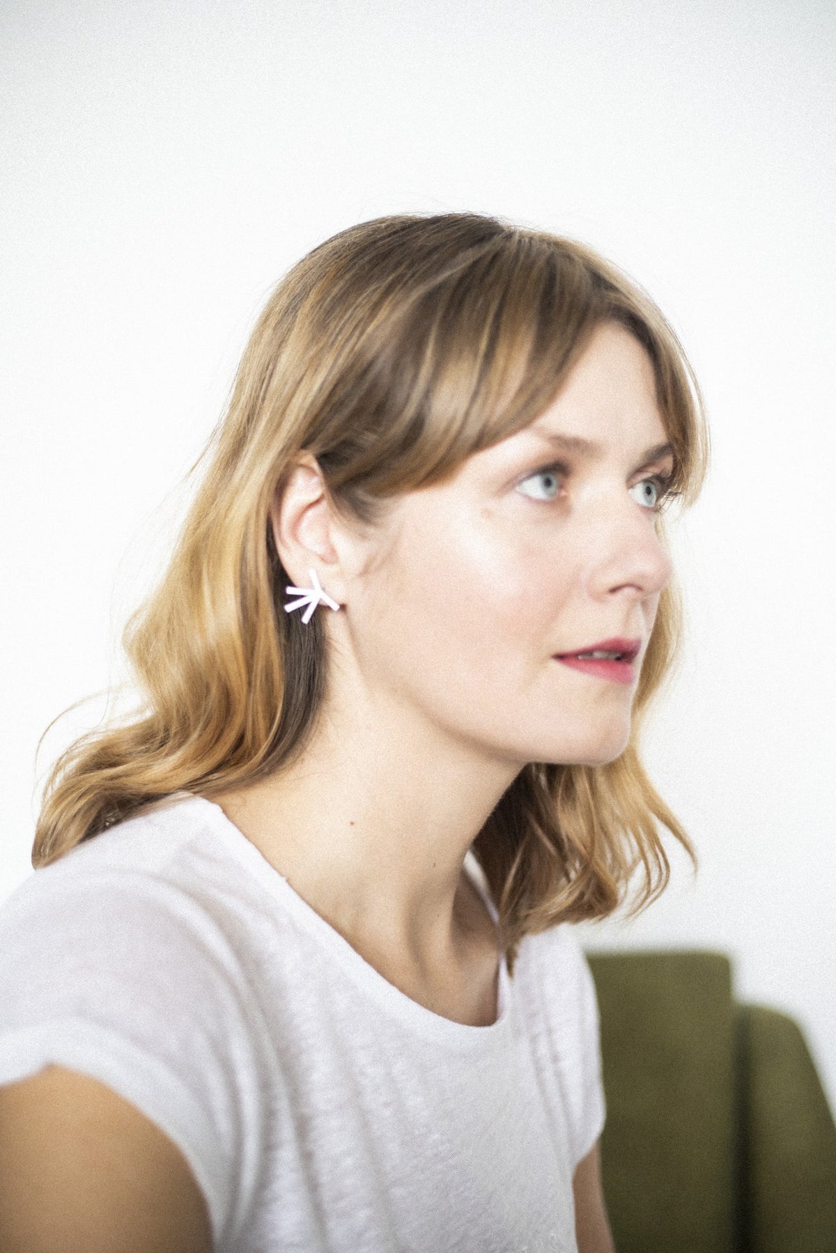 4. Woman wearing Lentsius Stella earrings, showing unique Scandinavian style