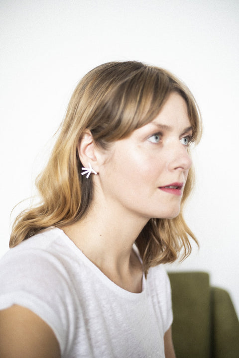 4. Woman wearing Lentsius Stella earrings, showing unique Scandinavian style